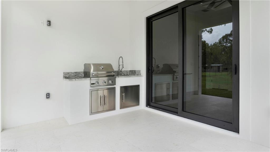 652 15th Street Southwest Naples, FL 34117 - Photo 43 of 47 a bathroom with a sink and a mirror