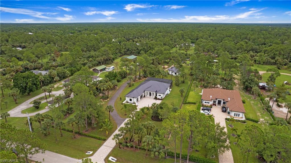 652 15th Street Southwest Naples, FL 34117 - Photo 44 of 47 an aerial view of residential houses with outdoor space and trees