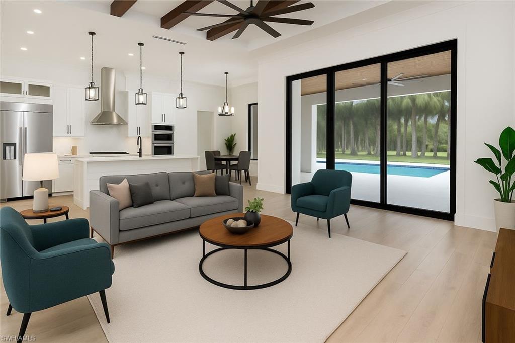 652 15th Street Southwest Naples, FL 34117 - Photo 6 of 47 a living room with furniture and a large window