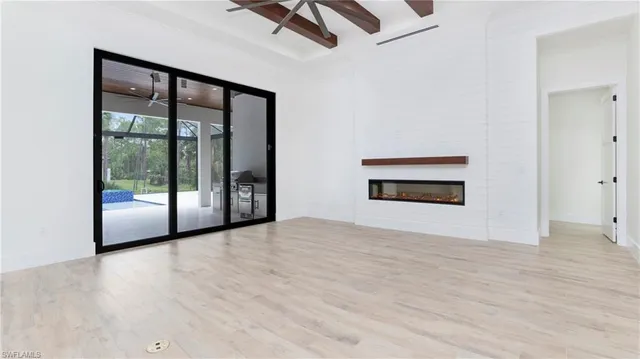 a large kitchen with stainless steel appliances kitchen island granite countertop a stove a sink and white cabinets