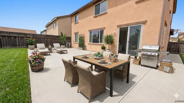 a view of a patio with table and chairs potted plants with floor to ceiling window