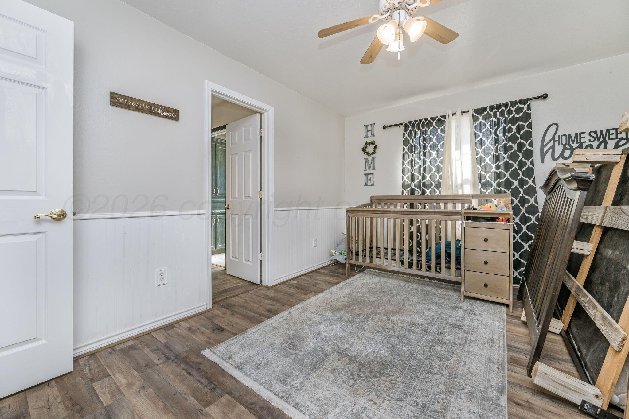 200 Hunters Trail Amarillo, TX 79124 - Photo 19 of 23 wooden floor in an empty room with a window