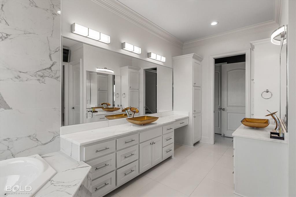 9480 McCain Road Shreveport, LA 71107 - Photo 19 of 40 a spacious bathroom with a double vanity sink and a large mirror