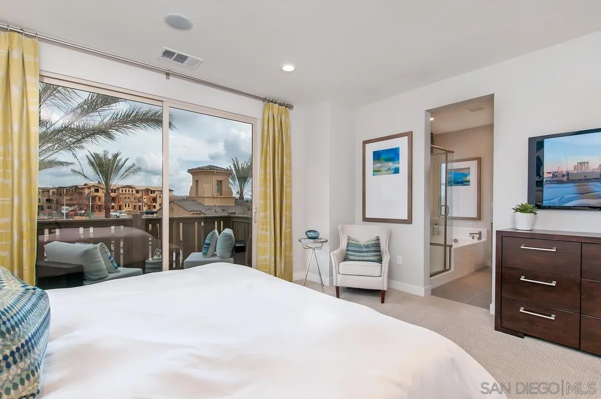 1189 Via Candelas Oceanside, CA 92056 - Photo 13 of 21 a bedroom with a bed and a large window