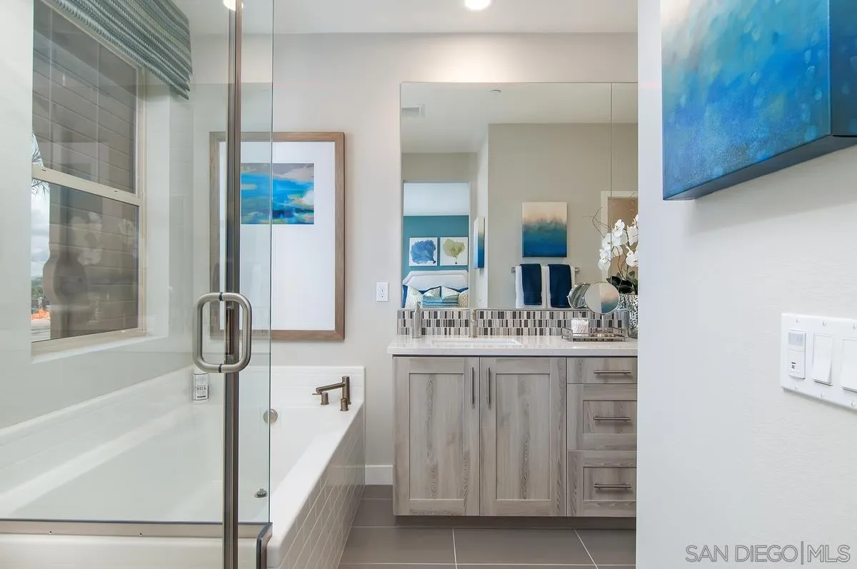 1189 Via Candelas Oceanside, CA 92056 - Photo 14 of 21 a bathroom with a sink a mirror and a bathtub