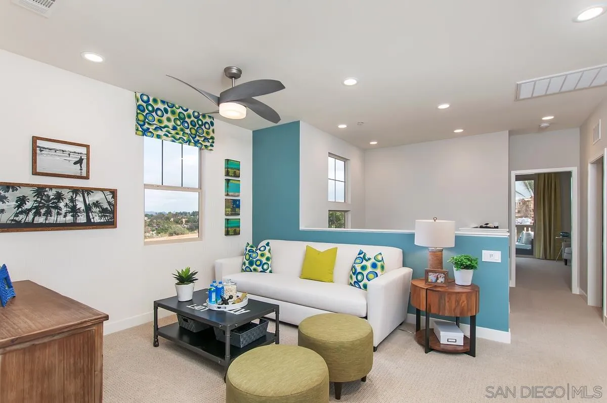 1189 Via Candelas Oceanside, CA 92056 - Photo 16 of 21 a living room with furniture and a dining table with wooden floor