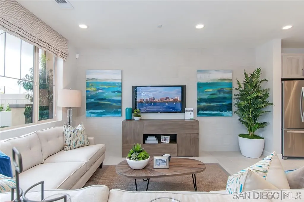 1189 Via Candelas Oceanside, CA 92056 - Photo 3 of 21 a living room with furniture a potted plant and a fireplace