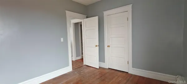 an empty room with wooden floor