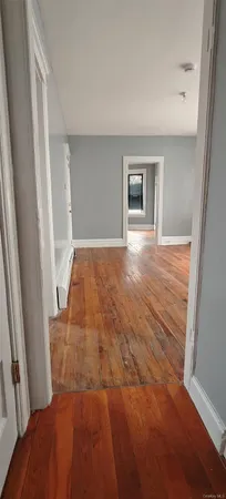 a view of an empty room and wooden floor