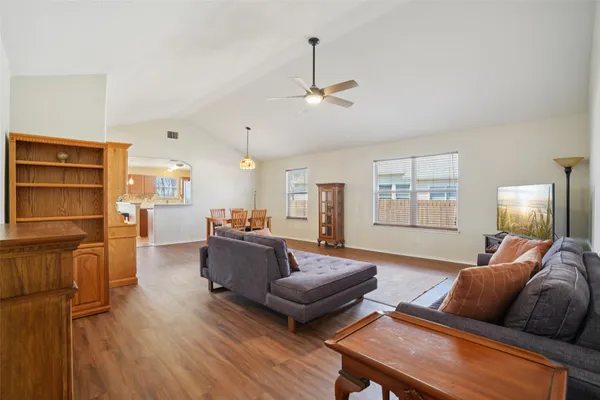 a living room with furniture and wooden floor