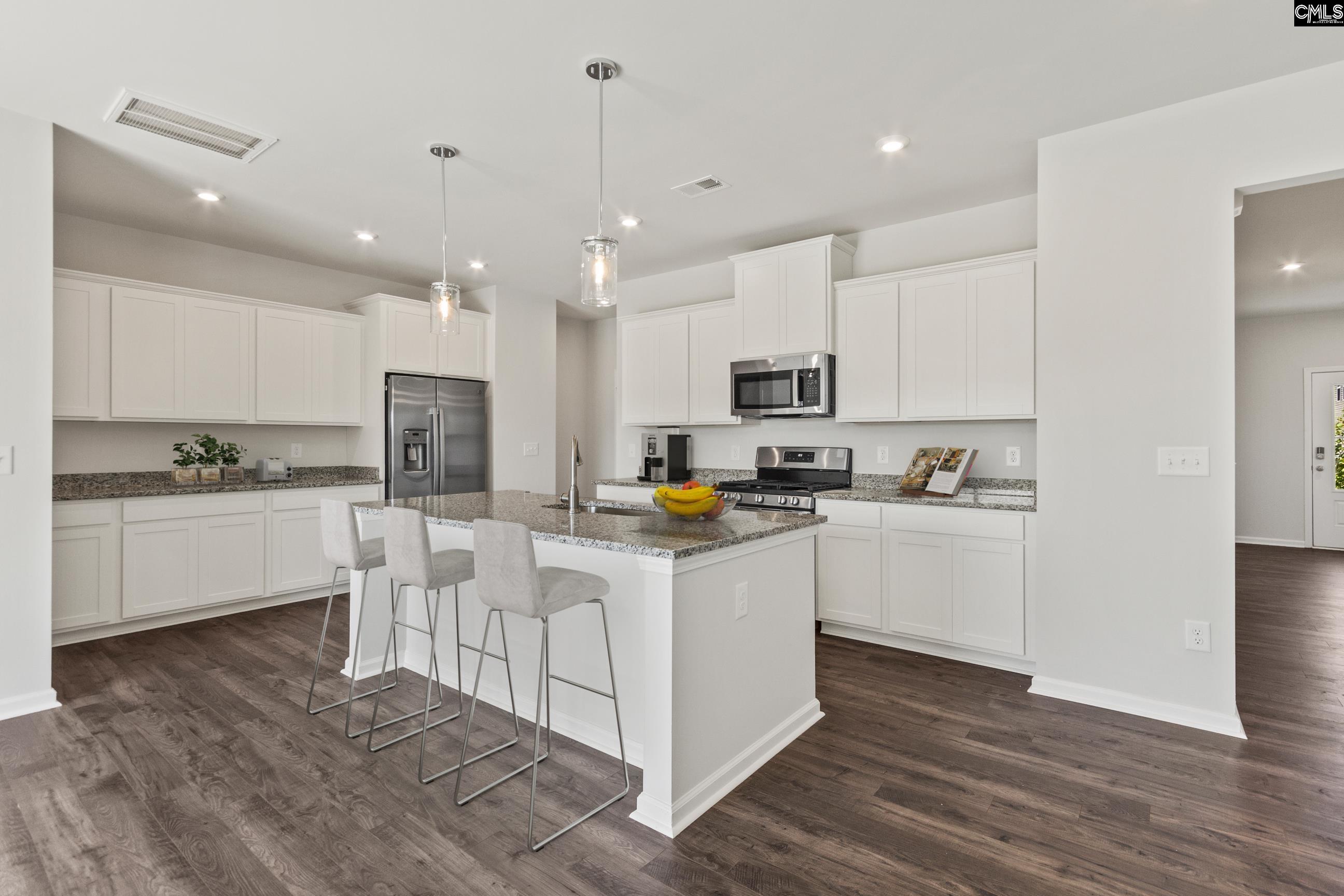 320 Brass Billion Path Lexington, SC 29073 - Photo 35 of 39 a kitchen with white cabinets and stainless steel appliances