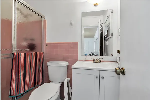 a bathroom with a sink toilet and mirror