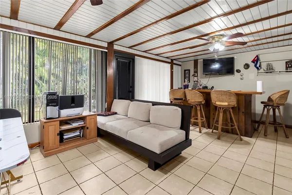a living room with furniture and flat screen tv