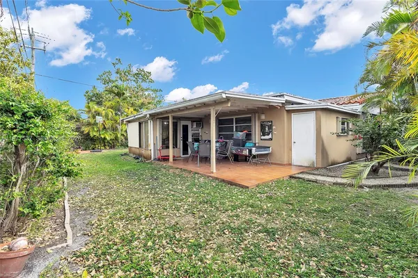 a view of a house with backyard porch and sitting area