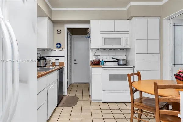 a kitchen with stainless steel appliances a refrigerator sink and cabinets
