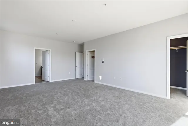 a view of an empty room and closet area