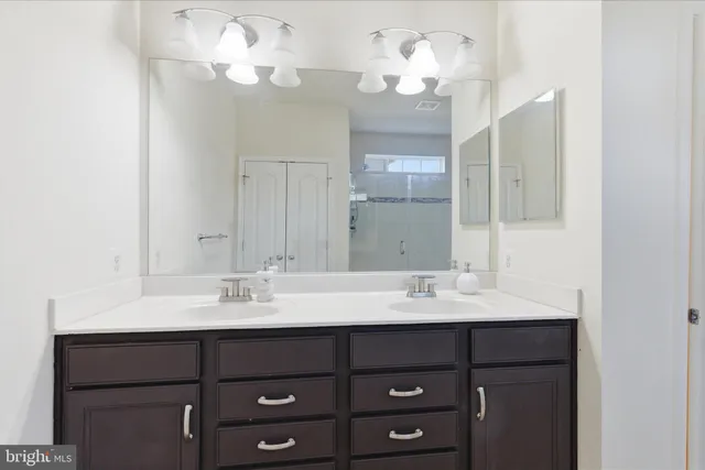 a bathroom with a sink vanity and a mirror