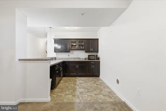 a kitchen with granite countertop a refrigerator and a stove