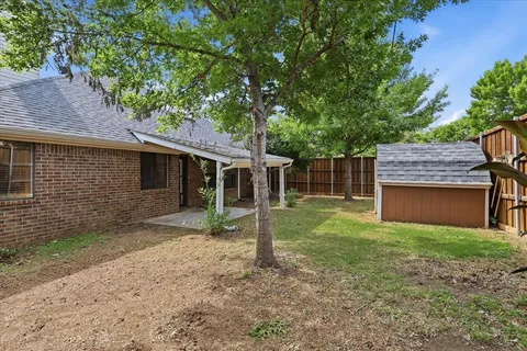 a backyard of a house with barbeque oven