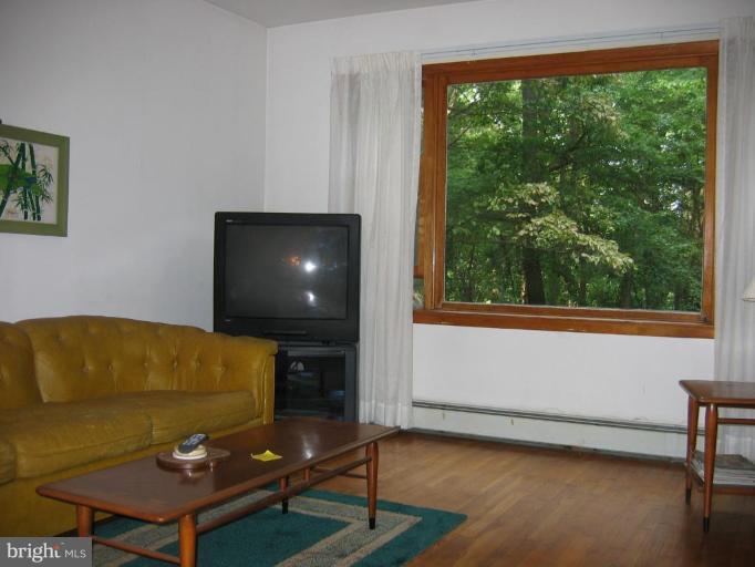 12510 Harford Road Hydes, MD 21082 - Photo 3 of 7 a living room with a couch and a large window