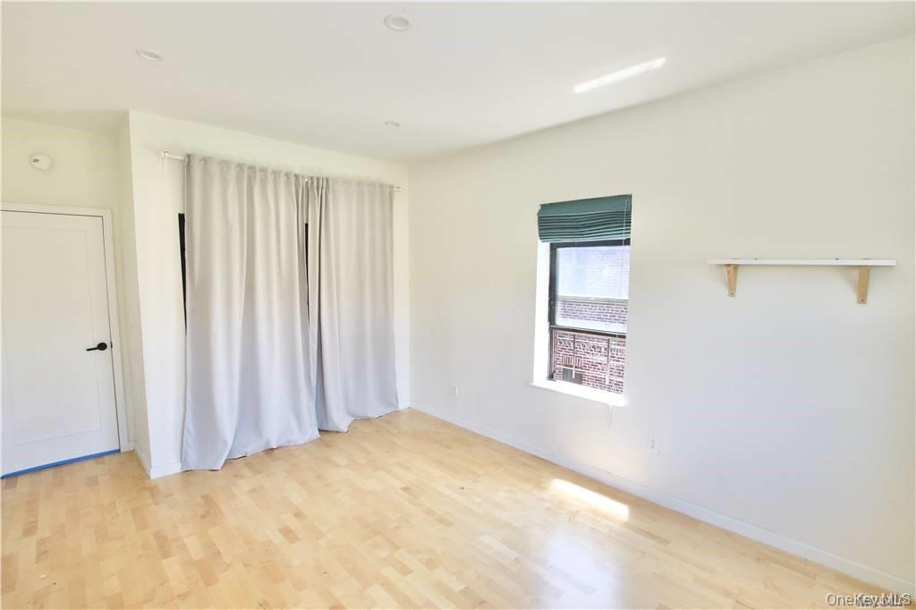43-33 48th Street, Unit 6D Queens, NY 11104 - Photo 12 of 14 a view of an empty room with a window