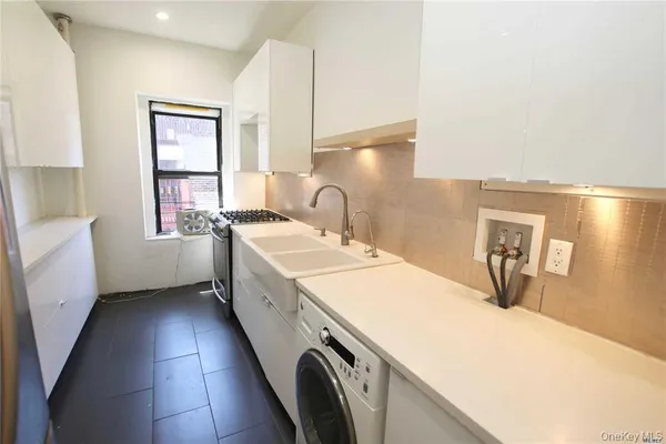 a kitchen with a sink stove and cabinets
