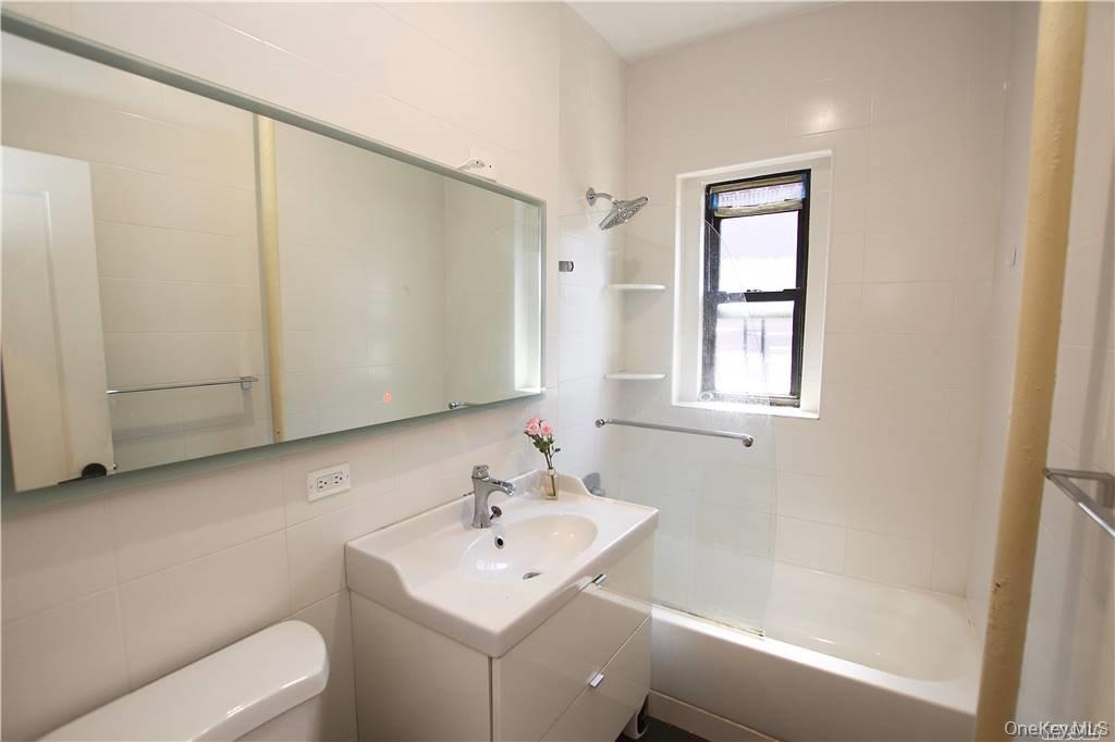43-33 48th Street, Unit 6D Queens, NY 11104 - Photo 9 of 14 a bathroom with a sink toilet and tub