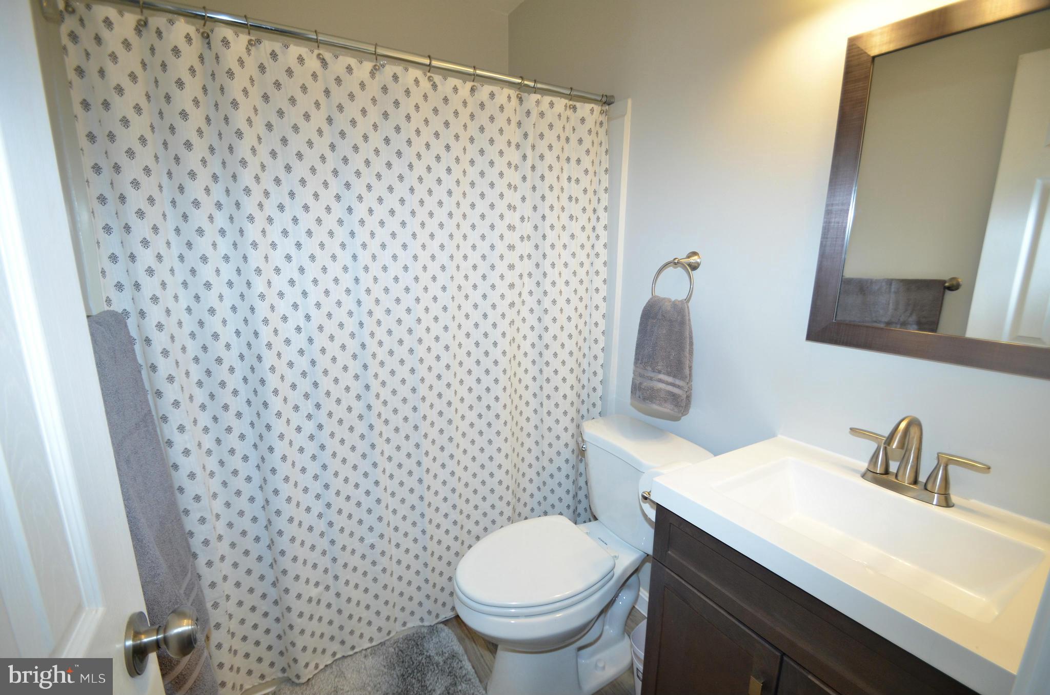 901 Beech Tree Road Severn, MD 21144 - Photo 13 of 27 a bathroom with a granite countertop toilet and a sink