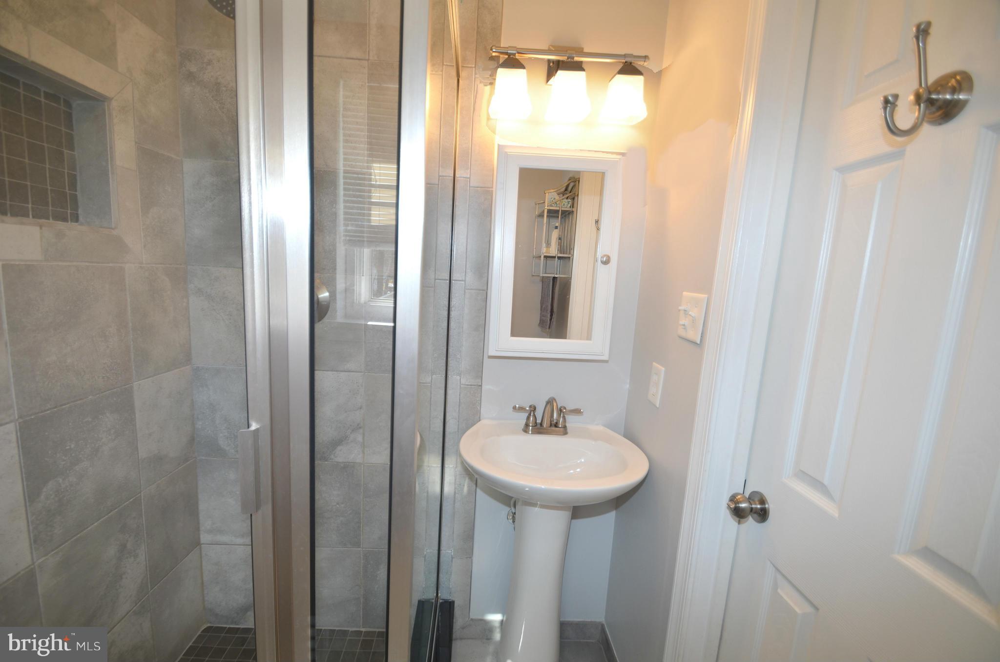 901 Beech Tree Road Severn, MD 21144 - Photo 15 of 27 a bathroom with a sink and mirror