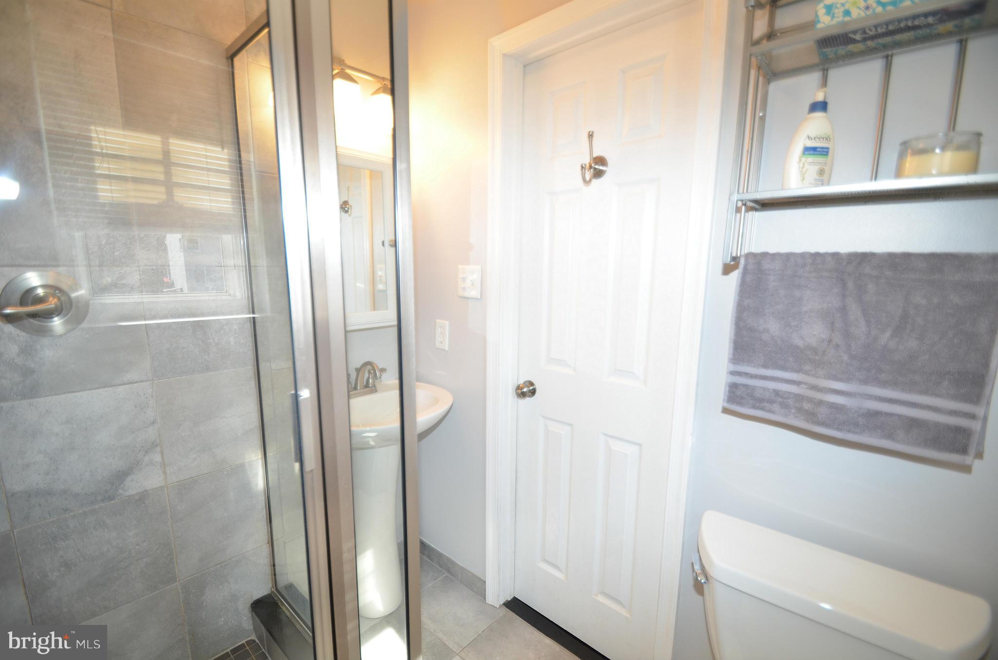 901 Beech Tree Road Severn, MD 21144 - Photo 16 of 27 a bathroom with a shower and toilet
