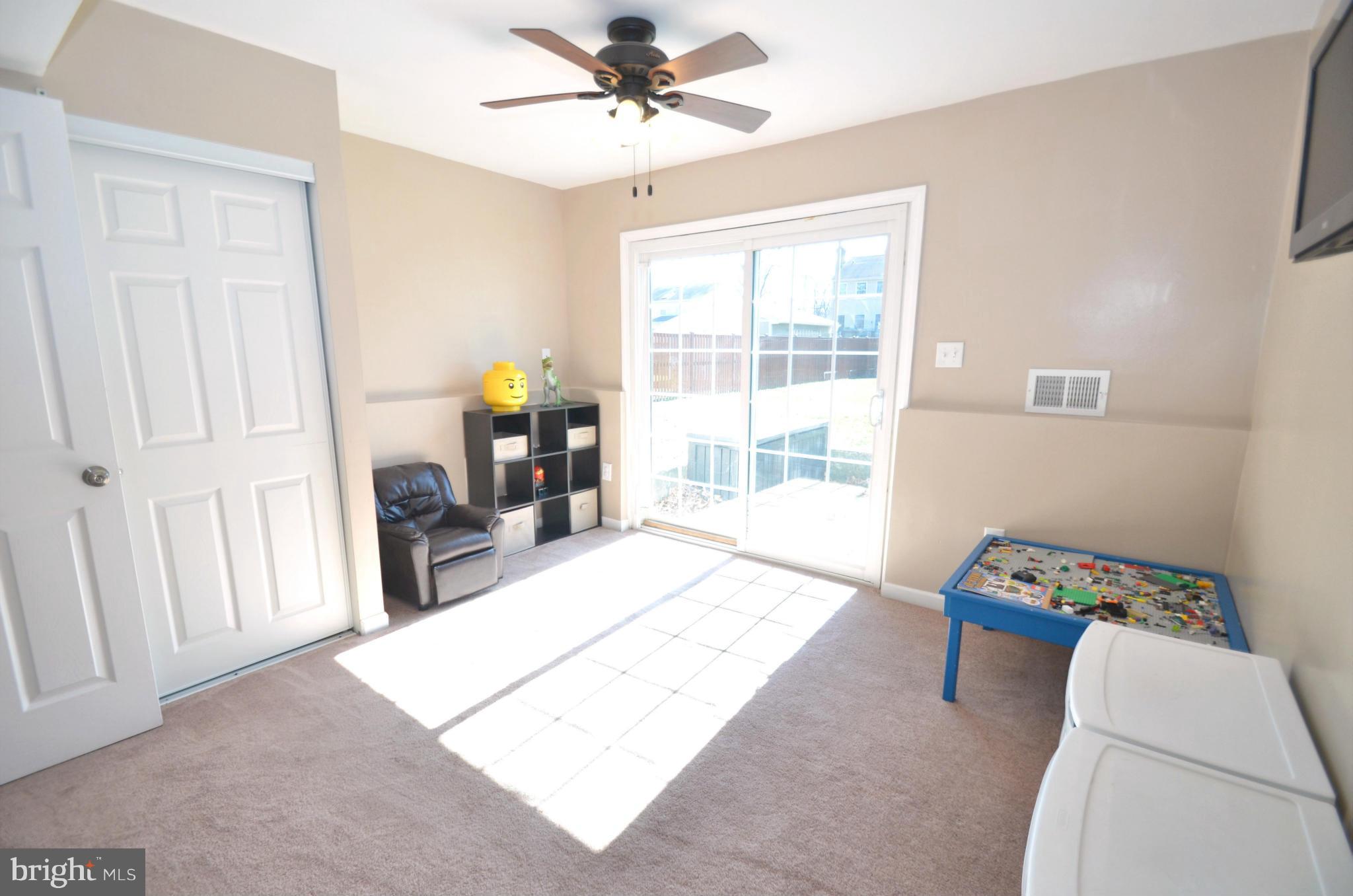 901 Beech Tree Road Severn, MD 21144 - Photo 19 of 27 a living room with a bed furniture and a window