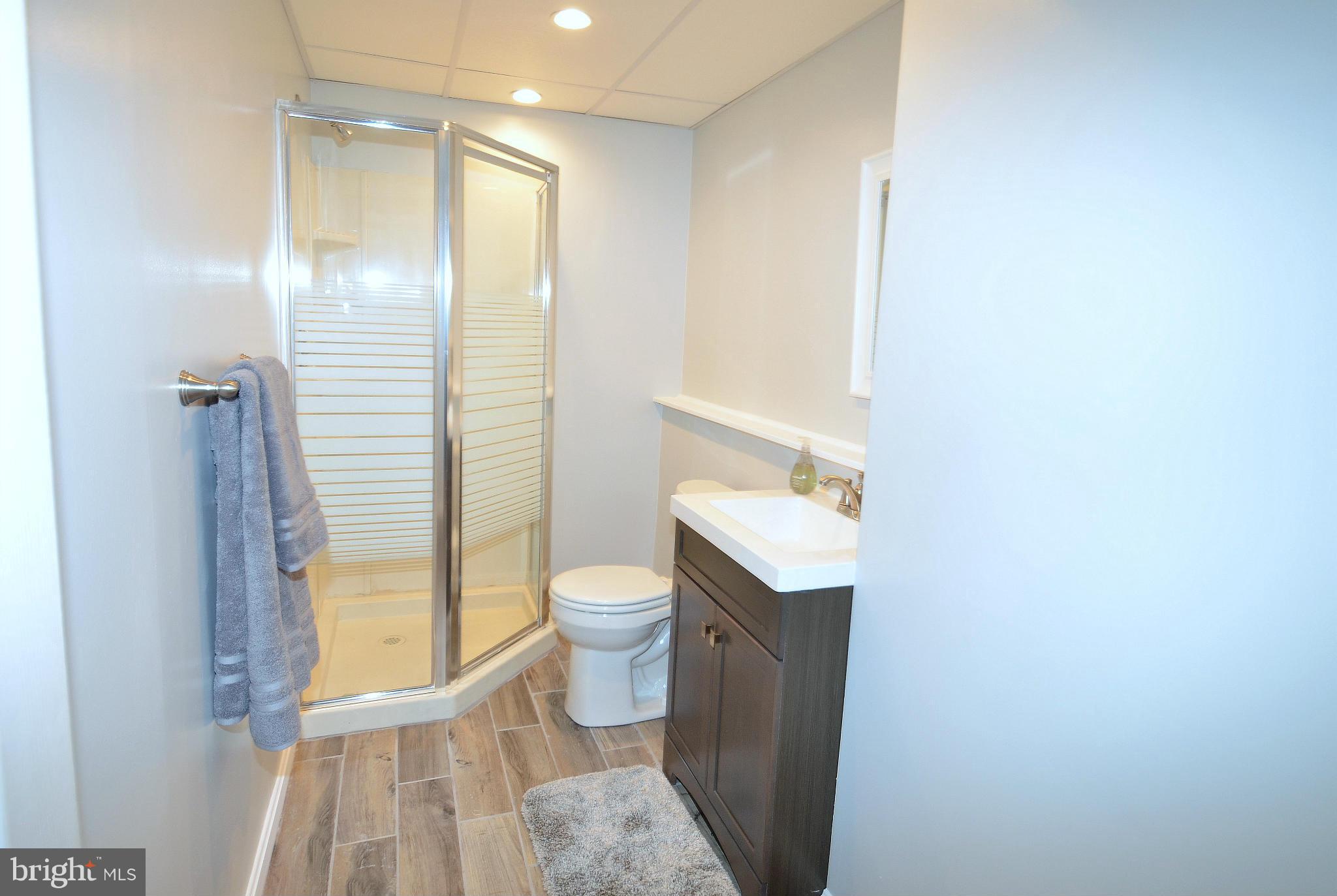 901 Beech Tree Road Severn, MD 21144 - Photo 20 of 27 a bathroom with a granite countertop sink toilet and shower