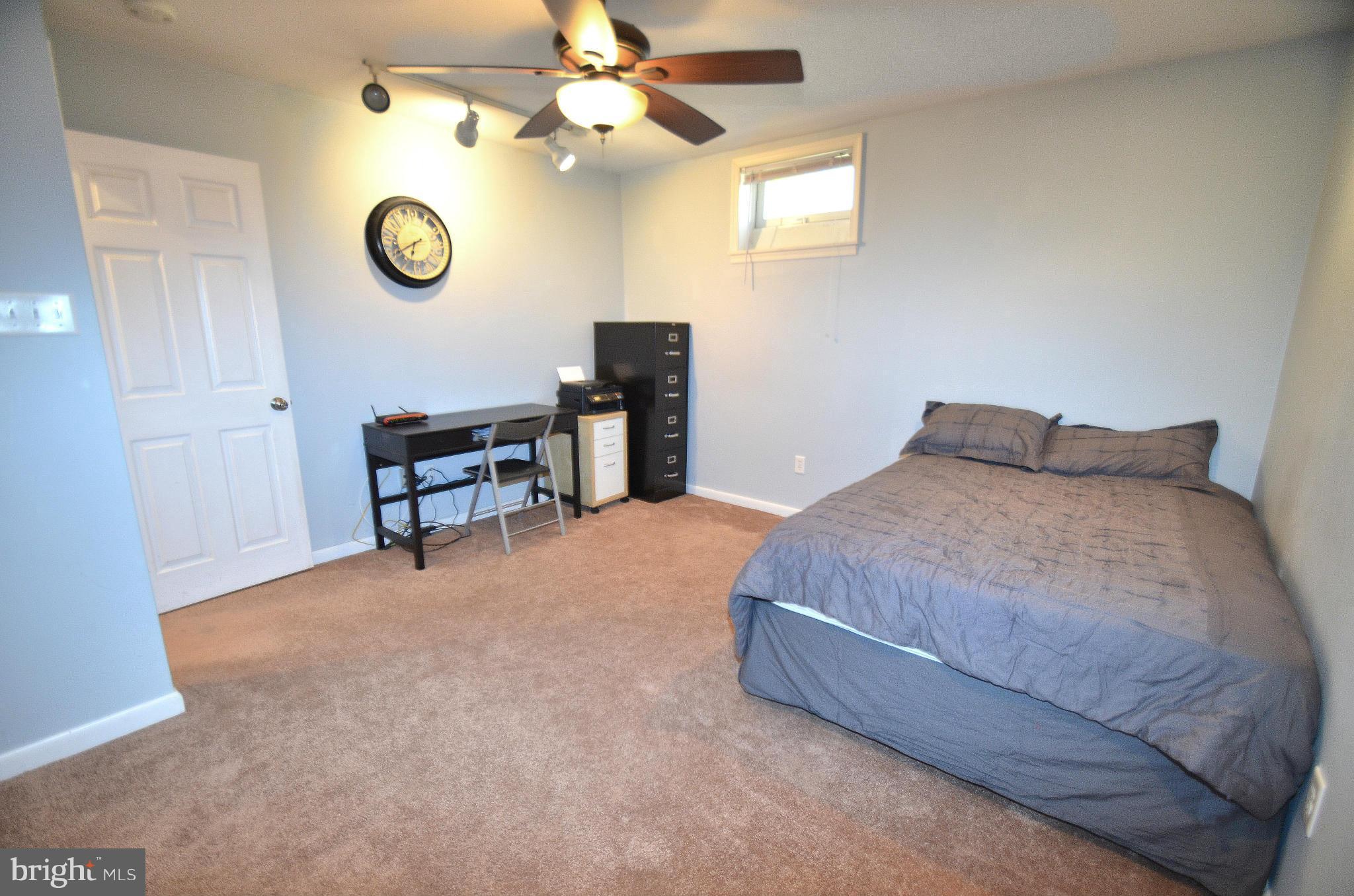 901 Beech Tree Road Severn, MD 21144 - Photo 21 of 27 a bedroom with a bed and a chandelier