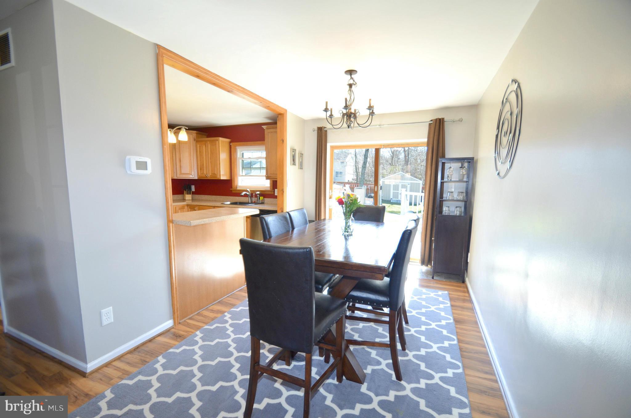 901 Beech Tree Road Severn, MD 21144 - Photo 6 of 27 a view of a dining room with furniture wooden floor and chandelier