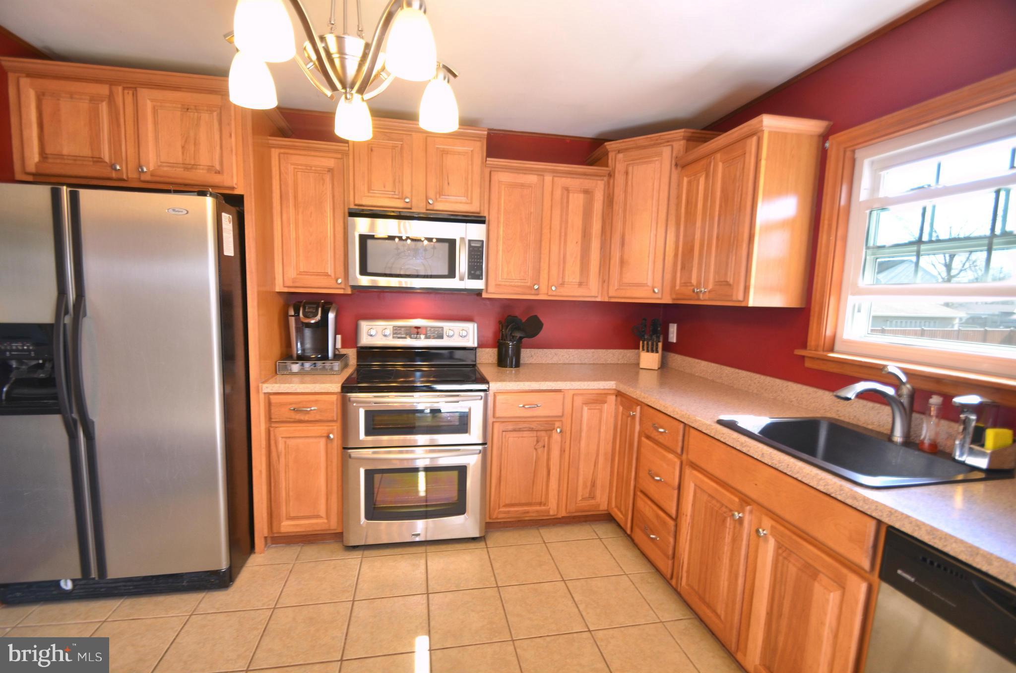 901 Beech Tree Road Severn, MD 21144 - Photo 7 of 27 a kitchen with stainless steel appliances granite countertop a refrigerator sink and microwave
