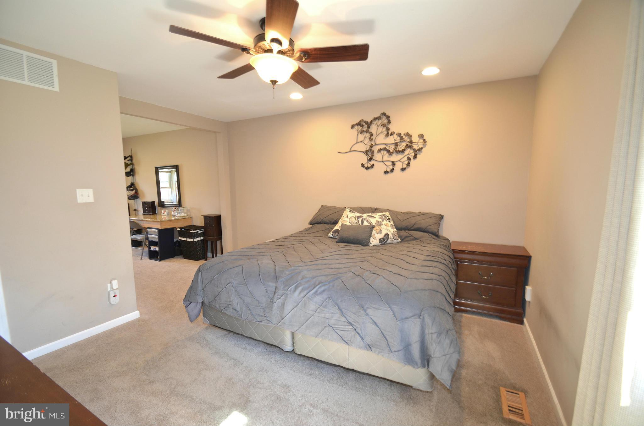901 Beech Tree Road Severn, MD 21144 - Photo 9 of 27 a bedroom with a bed and a chandelier