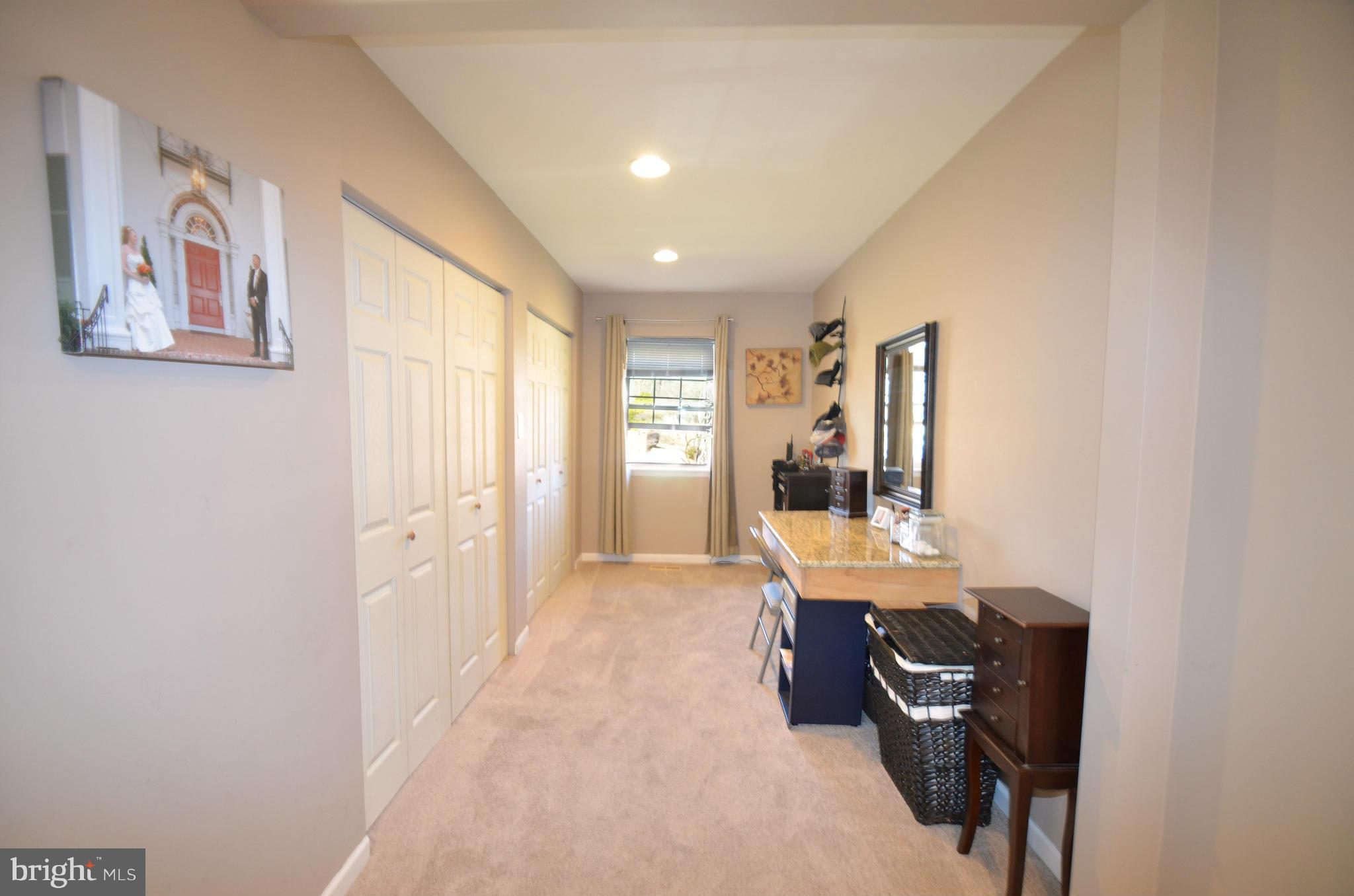 901 Beech Tree Road Severn, MD 21144 - Photo 10 of 27 a view of a hallway with workspace and window