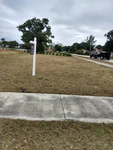a front view of a house with a lake