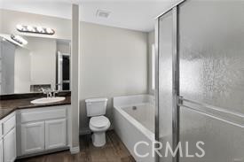 20726 Nisqually Road Apple Valley, CA 92308 - Photo 16 of 16 a bathroom with a granite countertop sink a toilet mirror and bathtub