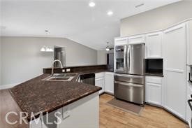 20726 Nisqually Road Apple Valley, CA 92308 - Photo 8 of 16 a kitchen with kitchen island a counter top space cabinets and stainless steel appliances