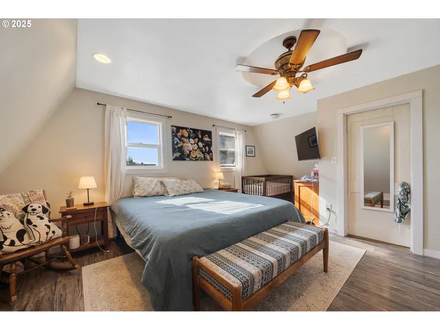 a bathroom with a toilet sink vanity granite and shower