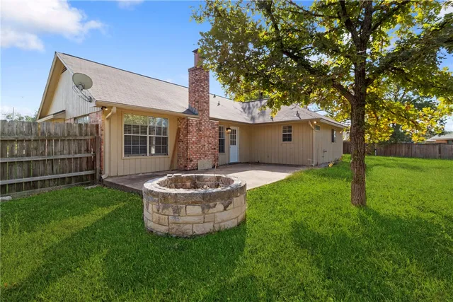 a front view of house with a garden