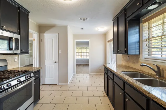 a kitchen that has a sink and a stove