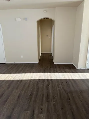 a view of a room with wooden floor