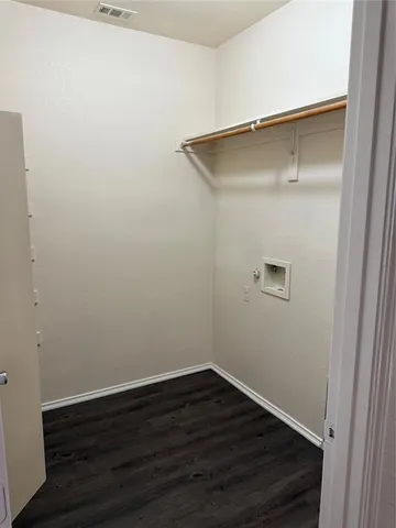 a view of a small space with wooden floor and closet