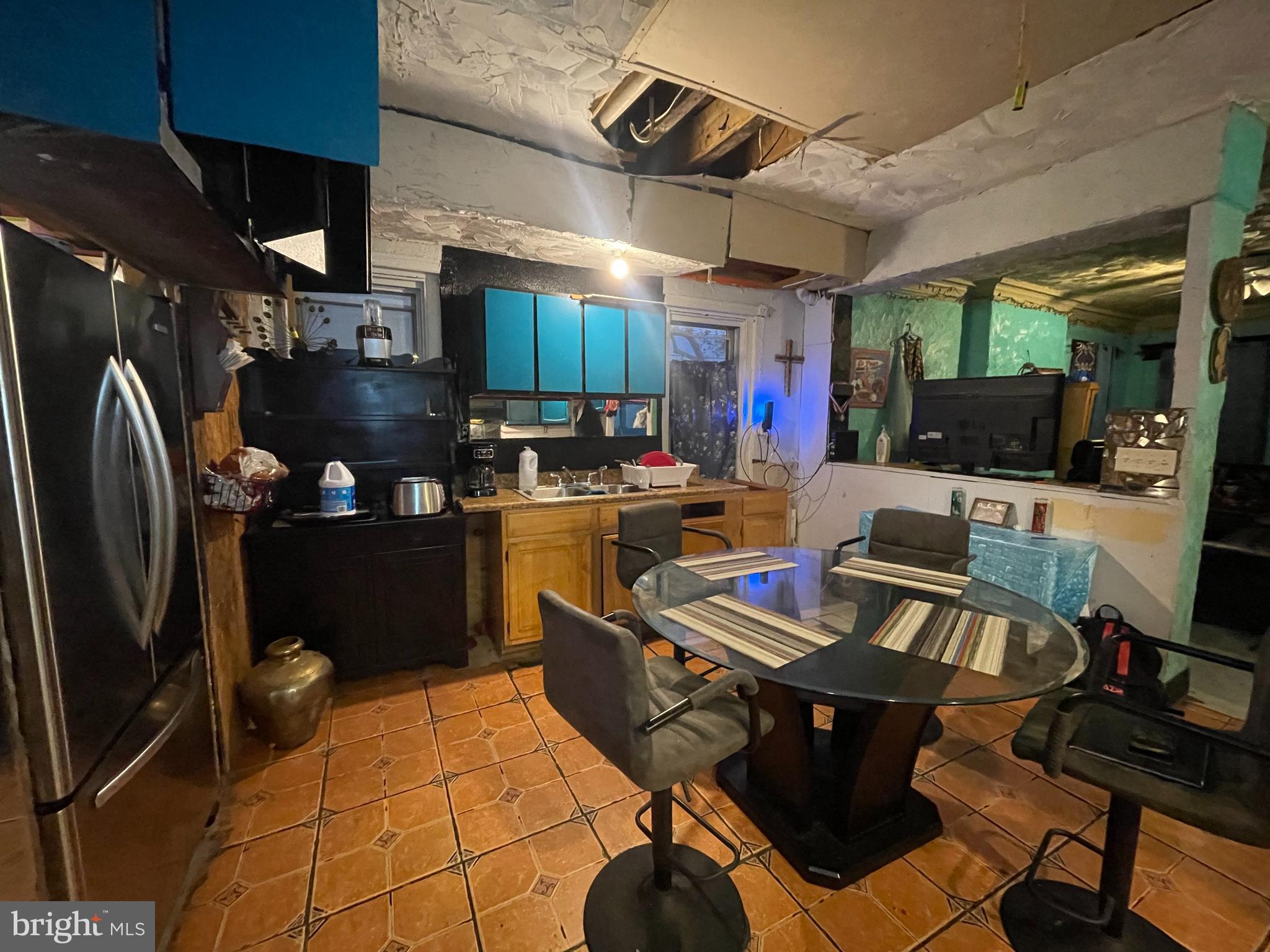 23 North 58th Street Philadelphia, PA 19139 - Photo 7 of 7 a kitchen with stainless steel appliances granite countertop a refrigerator a sink a stove and blue cabinets