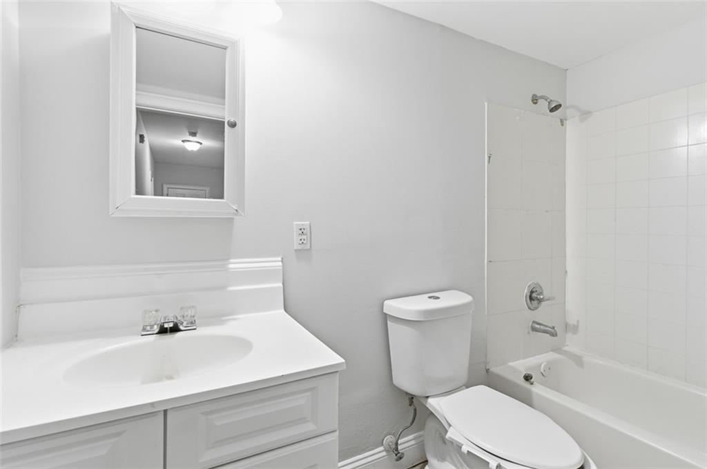 73 Atlanta Avenue Southwest Atlanta, GA 30315 - Photo 11 of 26 a bathroom with a sink a toilet and shower