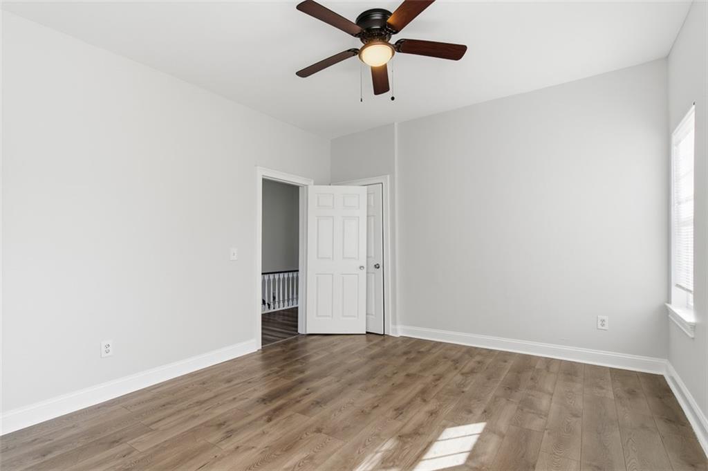 73 Atlanta Avenue Southwest Atlanta, GA 30315 - Photo 15 of 26 a view of a room with wooden floor and ceiling fan