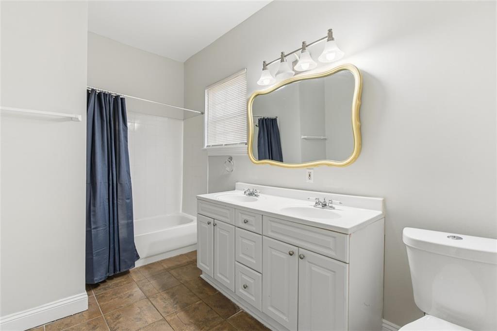 73 Atlanta Avenue Southwest Atlanta, GA 30315 - Photo 16 of 26 a bathroom with a toilet sink and mirror