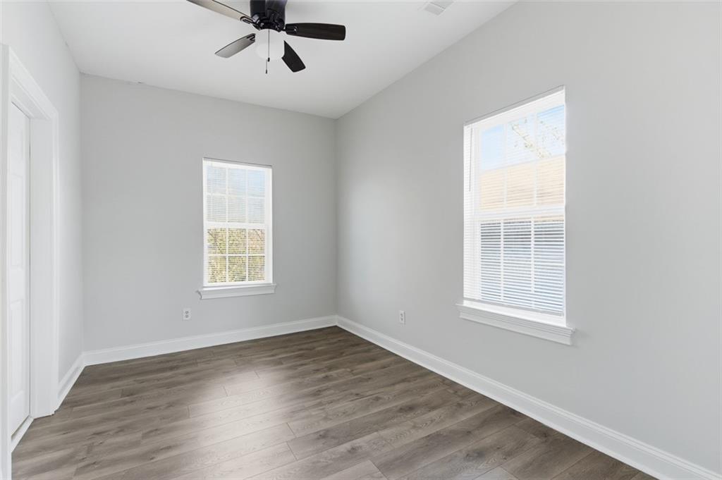 73 Atlanta Avenue Southwest Atlanta, GA 30315 - Photo 18 of 26 an empty room with wooden floor ceiling fan and windows